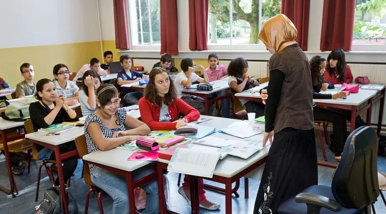 Belgian teacher Khadija wearing a headscarf in the classroom