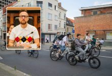 Cyclists riding through a traffic intersection in Ghent, Belgium.