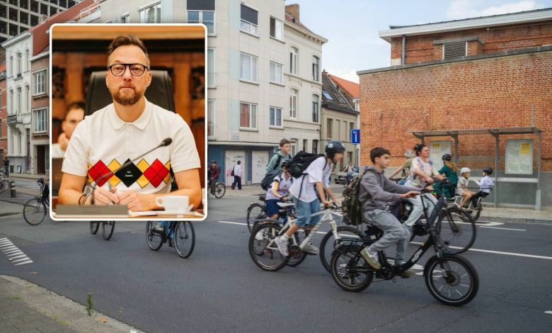Cyclists riding through a traffic intersection in Ghent, Belgium.
