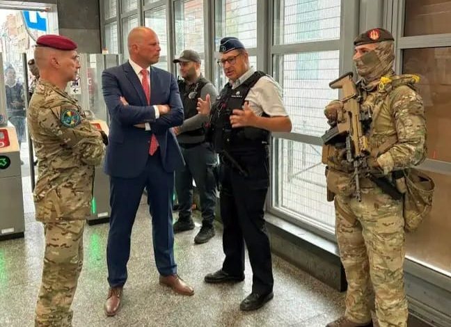 Belgian military personnel supporting police security operations at Brussels train and metro stations