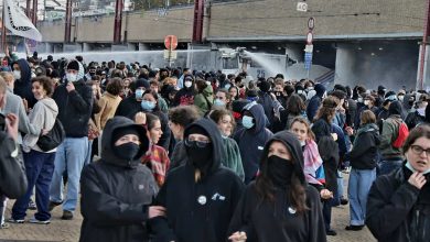 Belgian police use a water cannon to disperse protesters near Brussels-South railway station.